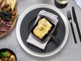 White and black Manufacture crockery, together with Artesano Original serving tableware, on a pristine white tabletop