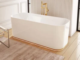 White Finion bath in a beige bathroom A white Finion bath with lighting and beige walls.