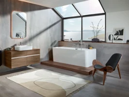 A modern bathroom with a wooden floor and an elegant Collaro bath by Villeroy & Boch.