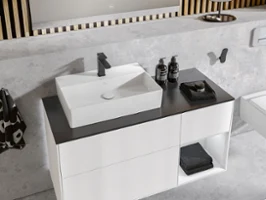 Minimalist washstand, black and white, with a rectangular white surface-mounted washbasin and a chrome tap