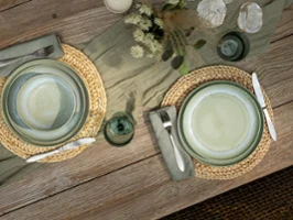 Perlemor Alga on rustic outdoor table with like glass Aerial shot of Perlemor alga on rustic table setting paired with like glassware.