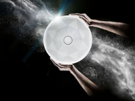 Close-up of two hands holding a radiant white washbasin against a dark background with swirling white particles.