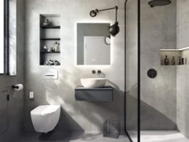 Un lavabo Artis blanc dans une salle de bains de style industriel avec des murs en béton.