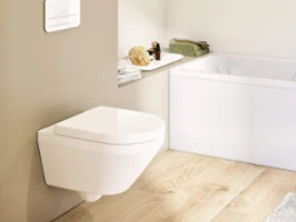 A white Architectura toilet with a flush plate in a Scandi-look beige bathroom