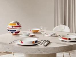 Oval stone table with modern colourful La Boule Miami. Shown assembled, then in individual pieces, arranged at a large window with a chair.