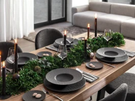 A modern holiday table setting featuring Rock Noir candle holders as elegant centerpieces.