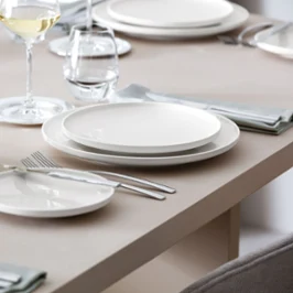 A table set with Afina plates shown in a side view to see the floating effect of the plates.