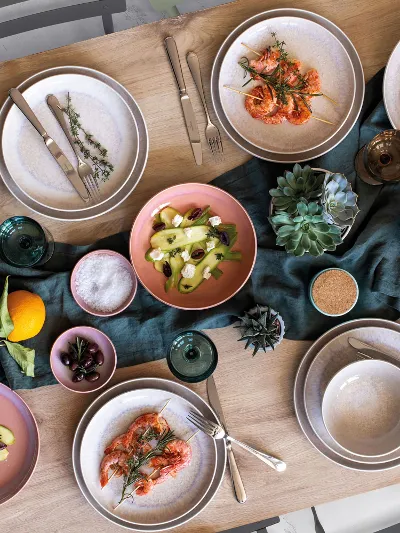 A table set with Perlemor tableware and Mediterranean food.