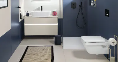 A blue and white bathroom with a toilet and washbasin from the modern Architectura collection by Villeroy & Boch.