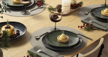 Elegant holiday Lave table set Elegant holiday Lave table set with desserts, candles, greenery, and berries on a wooden table.