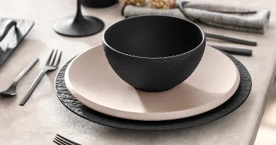 Closeup shot of Manufacture Rock bowl paired with NewMoon beige on a trendy table.