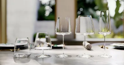 MetroChic glasses elegantly arranged on a polished table, with a blurred garden in the background.