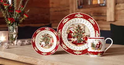 Festive Toy's Fantasy Christmas dinnerware on a wooden table with Christmas decorations in the background.