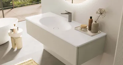 A white Antao vanity washbasin in a bathroom with a mirror and tap.