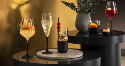 Various cocktails, elegantly presented in Manufacture glasses Various cocktails, elegantly presented in Manufacture glasses on a modern bar table with atmospheric lighting.