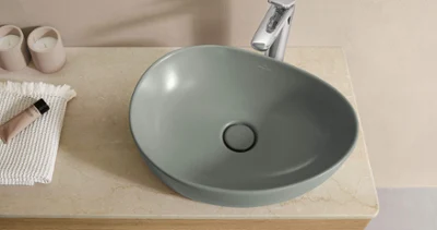 Green Antao surface-mounted washbasin with a tap A green Antao surface-mounted washbasin with a vanity unit and tap.