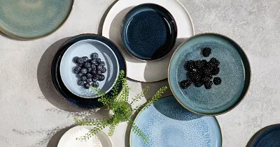 Various Crafted pieces with blueberries or blackberries, artfully arranged on a textured surface.