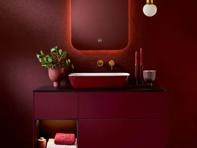 A bathroom with red walls and an Artis washbasin by Villeroy & Boch.