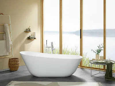 A white freestanding Theano bath in a Villeroy & Boch bathroom with a large window area.