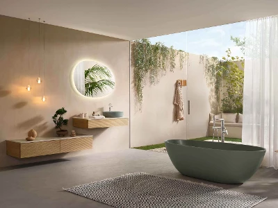 Minimalist Antao bathroom with ceramic in natural green Minimalist Antao bathroom with modern taps, a floating wooden washstand, a round mirror with backlighting, hanging lamps, a freestanding bath, a large window, plants and a view of the garden.