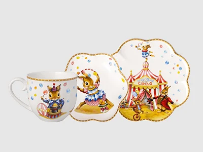 Collection image - Annual Easter Edition 2027 Three porcelain plates with wavy rim and illustrations and little bunnies in clothes.
