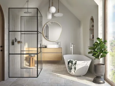 A white Theano Curved Edition bath in a light-coloured bathroom with a floor-to-ceiling window.