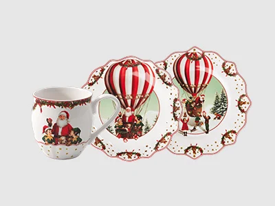 Collection image - Annual Christmas Edition 2026 Three porcelain plates with scalloped edges, each with colourful carousel and fairground scene illustrations.