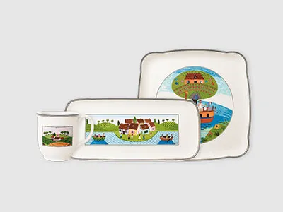 Geschirrset mit Tasse, Tablett und Teller, jeweils mit farbenfrohen Illustrationen von Häusern und Booten.