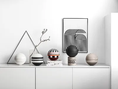 A white shelf with several La Boule crockery sets on top.