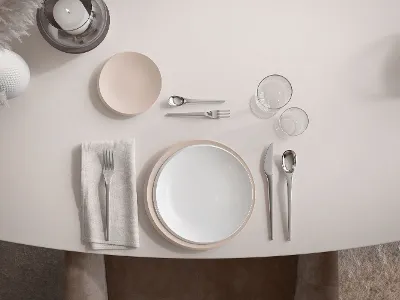 A set table with NewMoon dinnerware, flatware and utensils in subtle beige tones.