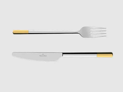 Eine Gabel und ein Messer aus Edelstahl mit gelben und schwarzen Griffen sind parallel auf einem schlichten hellen Hintergrund platziert.