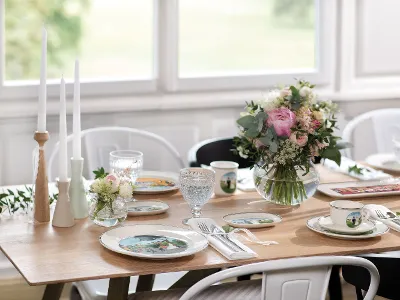 A romantic table setting with Design Naif tableware and NewMoon cutlery along with flowers and candles.