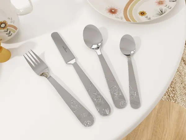 A four-piece children's cutlery set – fork, knife, tablespoon, and teaspoon – neatly arranged on a white table with the 'Boho Kids | Roar like a Lion' collection by Villeroy & Boch.