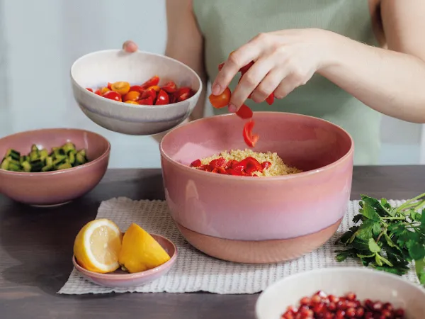 A woman preparing a couscous salad in a like. by Villeroy & Boch Perlemor salad bowl.