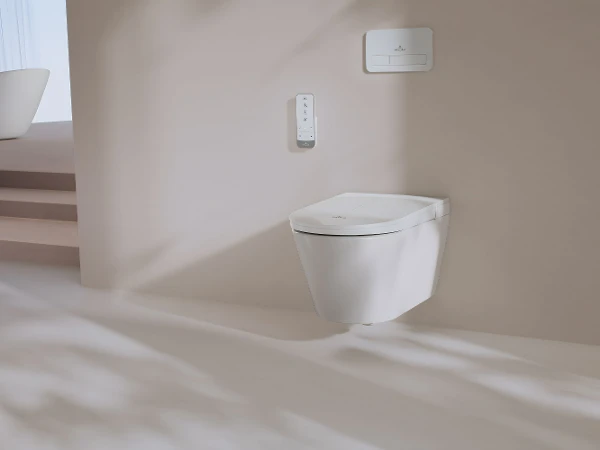 Vegghengt Tivo dusjtoalett i beige baderom Det vegghengte Tivo dusjtoalettet fremhever moderne eleganse i et lyst beige baderomsinteriør.