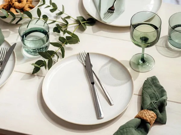 Crafted Cotton dinner plate with like Glass glasses and Piemont cutlery by Villeroy & Boch decorated with eucalyptus branches.