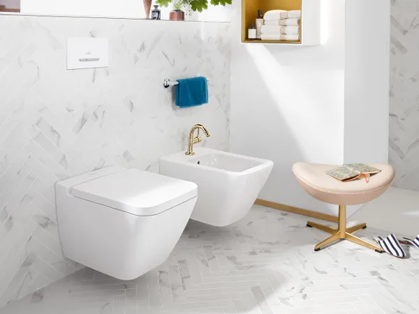 Finion toilet and bidet in white by Villeroy & Boch with stool and slippers.