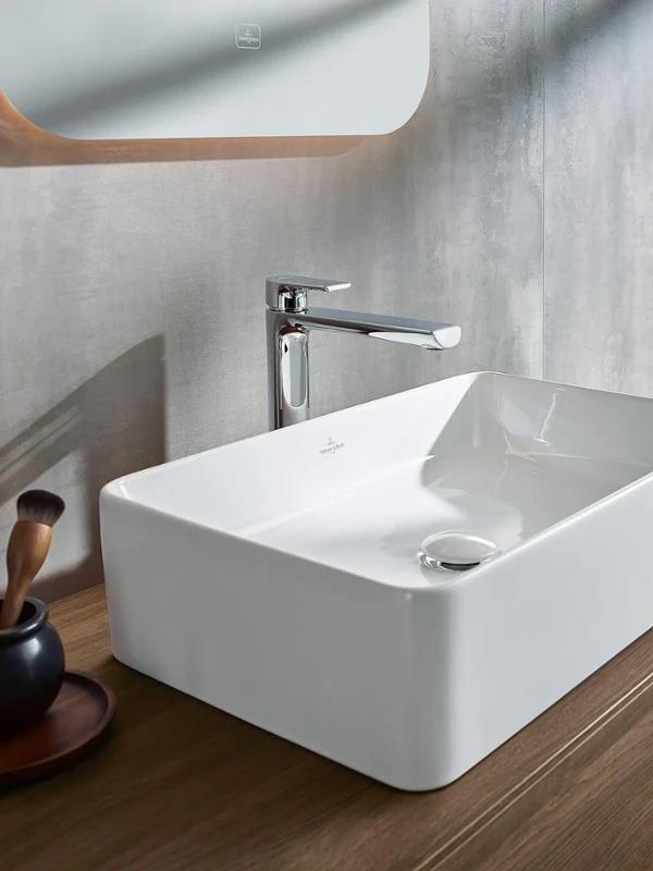 Collaro washstand and vanity units in a modern bathroom with a sea view Modern bathroom design with a washbasin and wooden cabinets from the Collaro collection against the background of a window with a sea view.