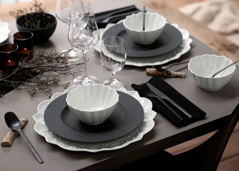 A table set with Villeroy & Boch black Manufacture plates and white Toy’s Delight tableware.