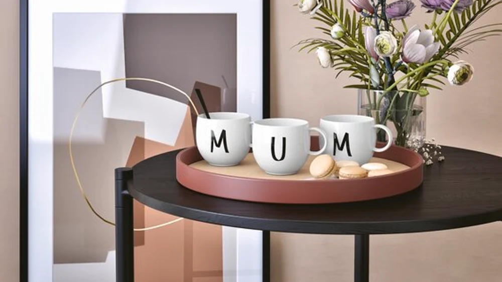 Letters Mugs spelled Mum on Table with Flowers