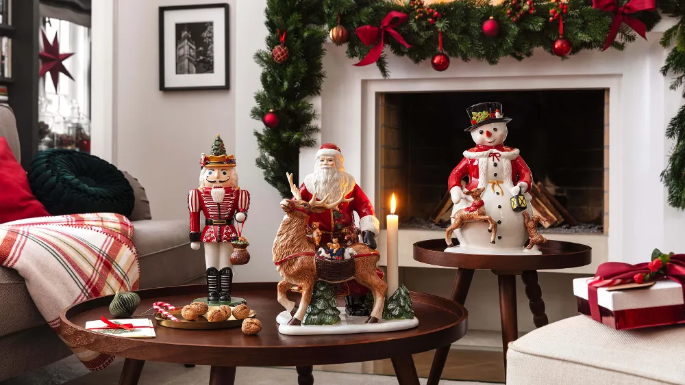 Christmas Toy's Memory on a table Living room decorated for Christmas with garlands, candles, figures and wrapped presents next to a fireplace and a coffee table.