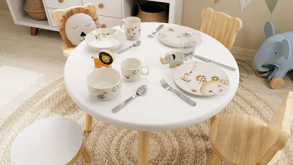 A table setting in a children's room with Boho Kids crockery, cutlery and glasses in an animal theme in pastel colours.