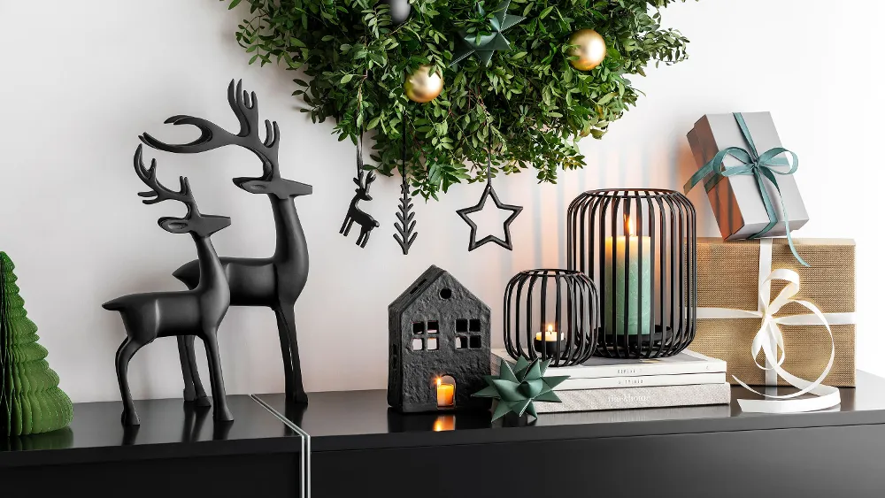 Une décoration de Noël Black XMAS Une décoration de Noël moderne Black XMAS avec une couronne verte sur un manteau de cheminée.