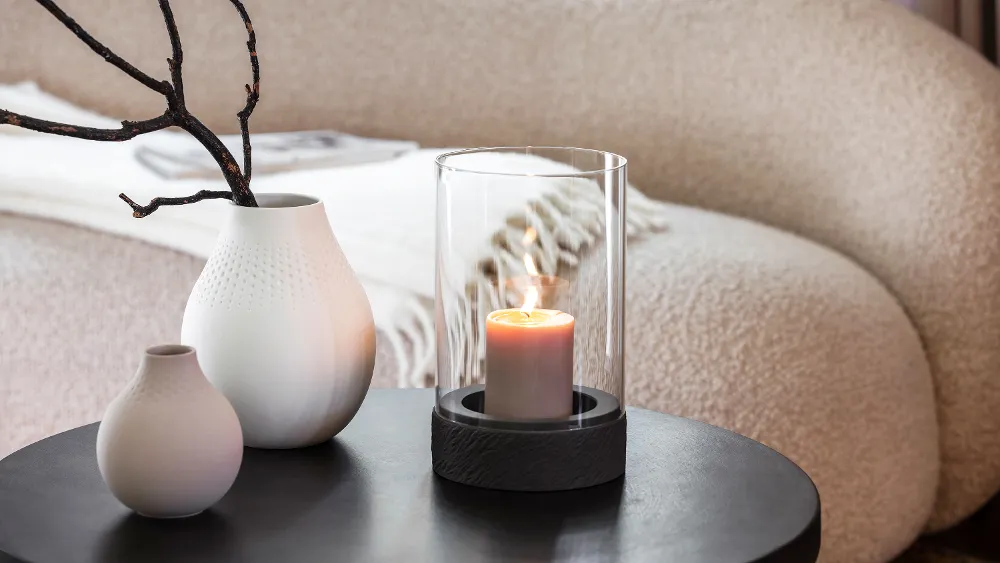 Manufacture Rock Home lantern styled with Collier Perle vases in soft white and beige tones for a serene interior.