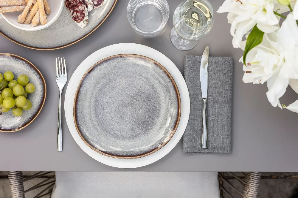 Gedeckte Tisch mit Manufacture blanc, Lave beige Teller und Piemont Besteck.