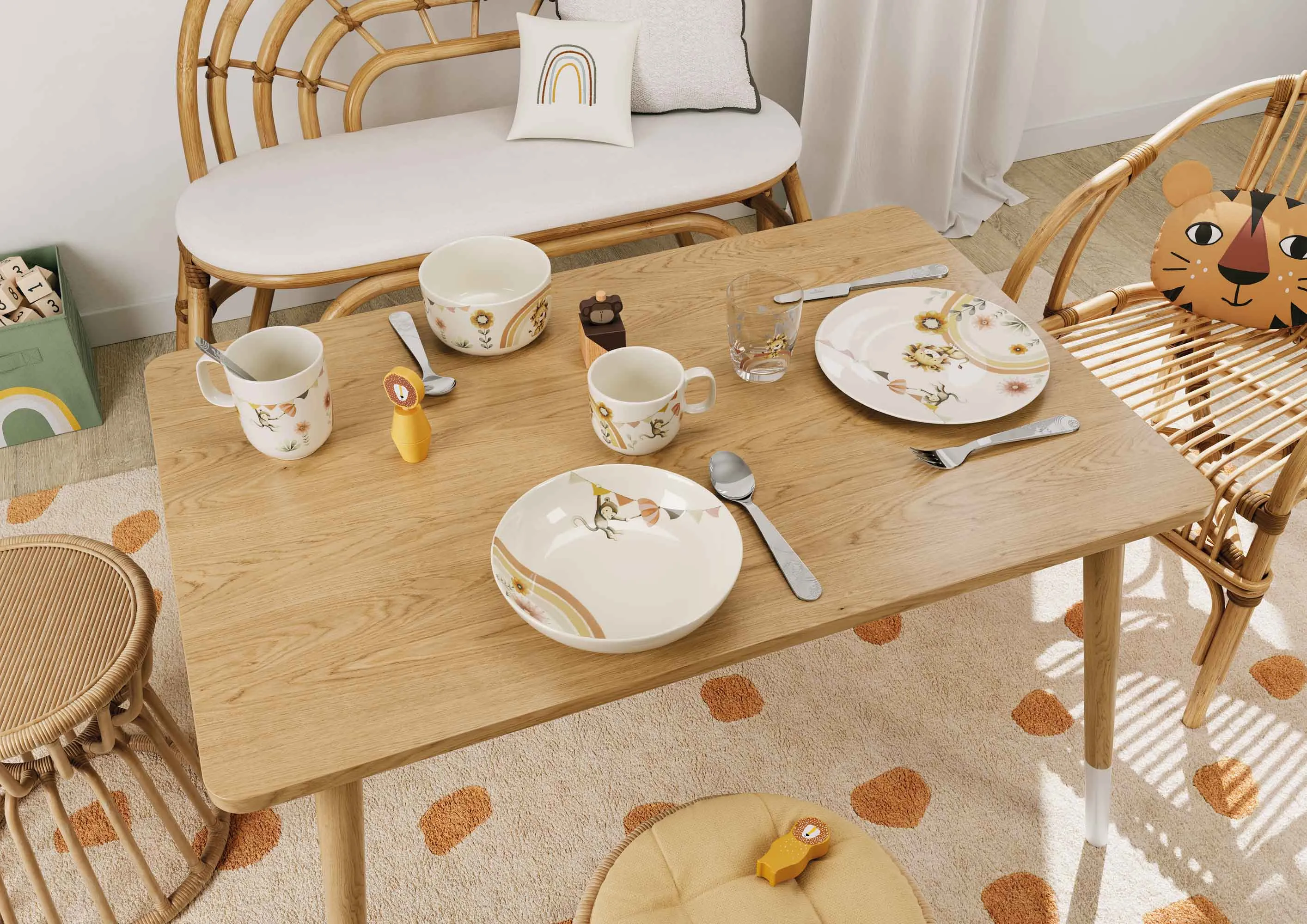 A cosy dining room with a wooden table, wicker chairs and colourful Boho Kids Roar like a Lion children’s crockery.