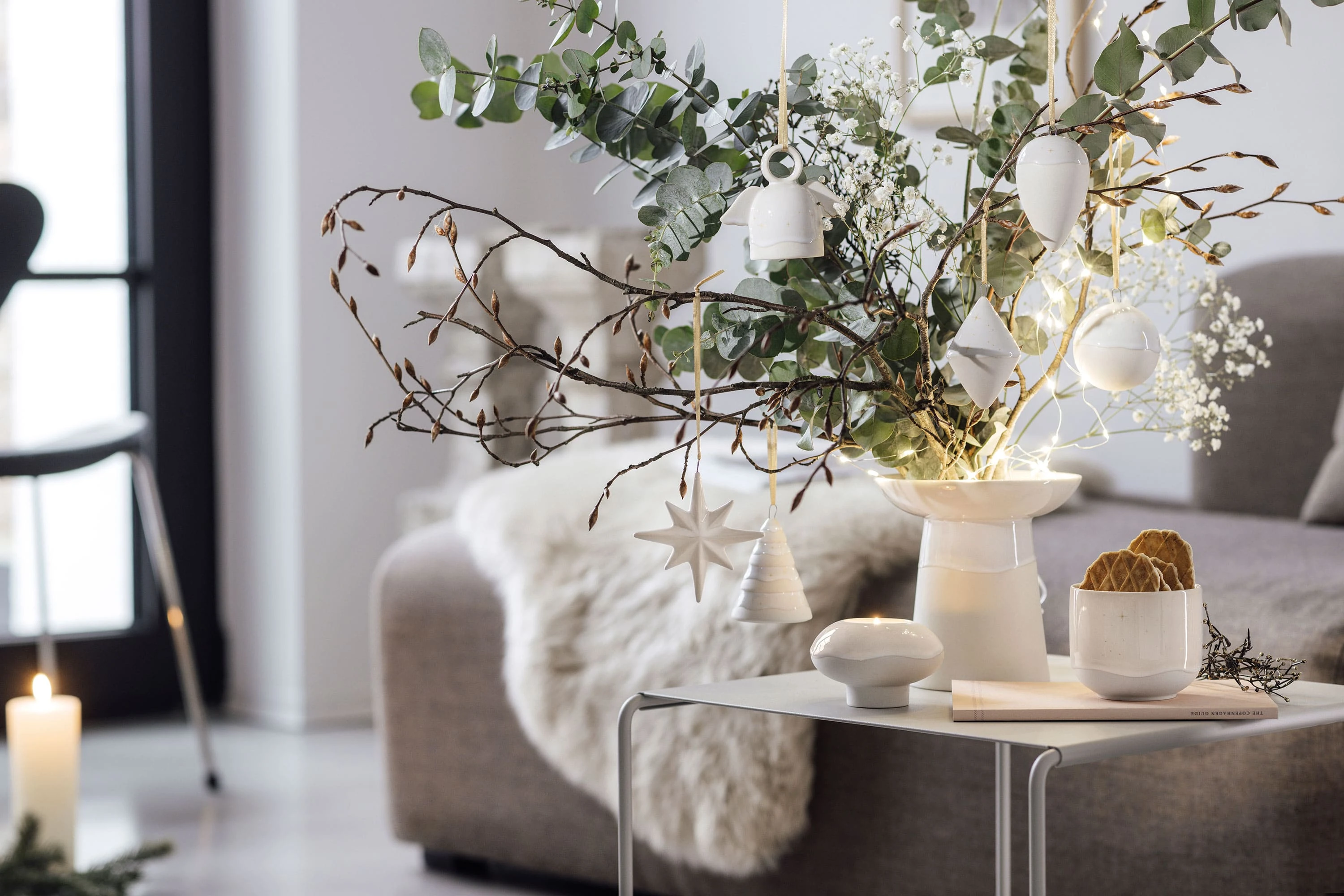 Twigs decorated with Winter Glow ornaments in a living room A living room decorated with Villeroy & Boch Winter Glow ornaments.