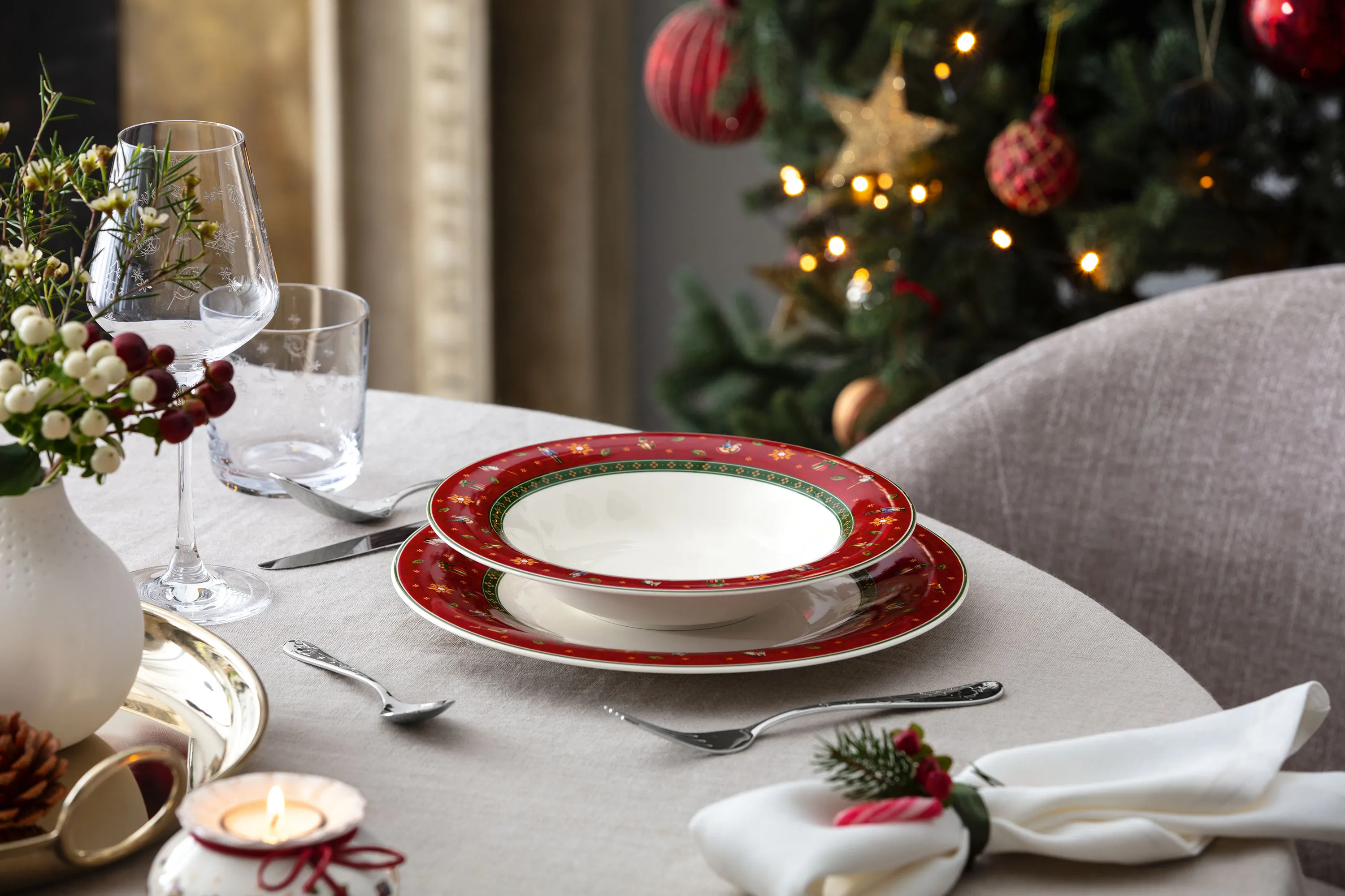 Toys Delight Plates and Manufacture Blanc Vase Styling Elegant Toys Delight holiday plates with decorative accessories and a Manufacture Blanc vase styled for a festive table setting.