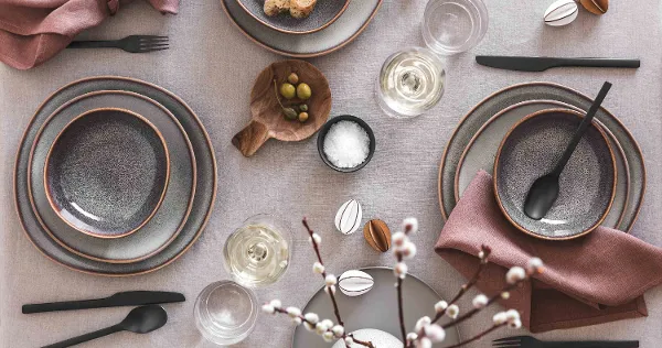 Elegant table decoration with Lave crockery, Manufacture cutlery and simple Easter decorations in a neutral colour palette.