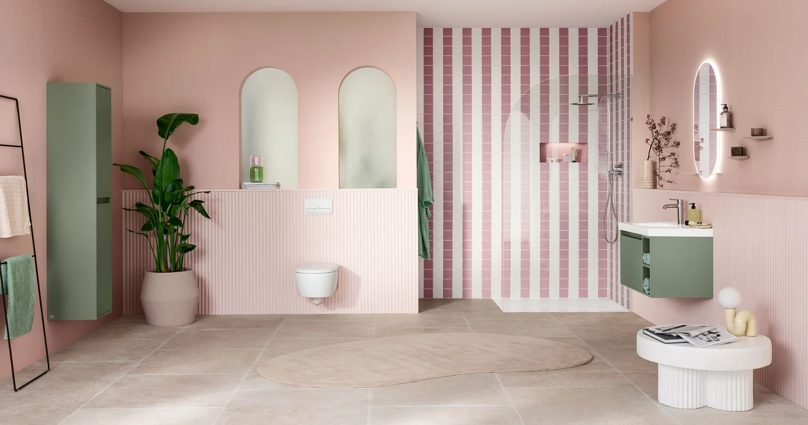Modern bathroom with pink walls, striped shower area, green accents, large mirrors and a potted plant.
